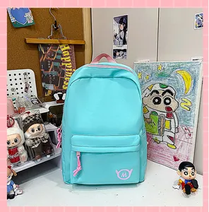 Stylish light blue school backpack for teen girls shown in a cozy desk study scene