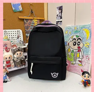 Detail shot of black school backpack with purple trim in a lifestyle setting