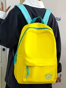 Vibrant yellow large capacity student backpack with contrasting blue straps and minimal logo.
