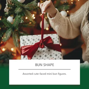 Close-up of a star-patterned Christmas gift box with a red ribbon held by hands.
