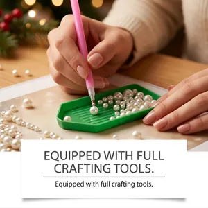 Close-up of DIY Christmas pearl diamond painting tools including pick-up pen and tray.