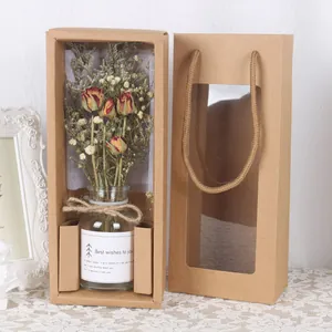 Detailansicht von getrockneten Rosen in Glasflasche mit Kraftpapier-Geschenkverpackung.