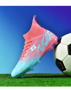 Vibrant pink and blue gradient high-top soccer cleat shown on a professional grass field