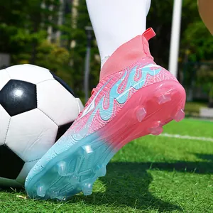 Professional youth football boots with gradient pink-blue design for grass training