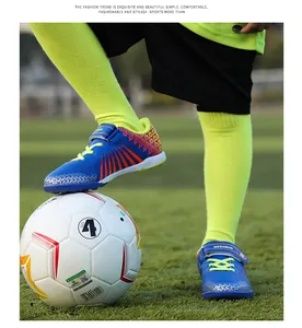 Close-up detail of youth blue TF soccer shoes being worn on a soccer ball outdoors