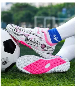 Detail view of children's warm soccer turf shoes with plush lining and pink studs