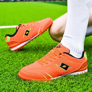 Professional vibrant orange men's and kids' TF turf soccer shoes with non-slip sole