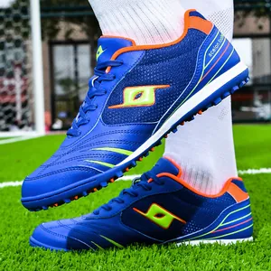 Professional blue turf soccer shoes with spikes for adult and youth players.
