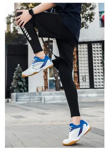 Action shot of youth blue and white badminton shoes worn in an outdoor street setting