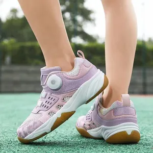 Detailansicht atmungsaktiver lila-rosa Kinderbadmintonschuhe auf einem Sportplatz