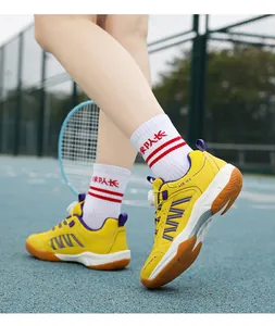 Yellow children's badminton shoes with rotating buckle on outdoor sports court