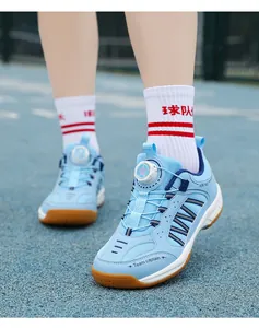 Macro view of sky blue kids badminton shoes featuring an adjustable rotating dial system