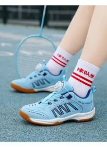 Close-up detail of light blue children's badminton shoes with a rotary dial system.