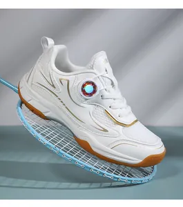 Close-up detail of children's white badminton shoe with breathable mesh and gold trim