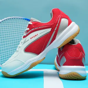 Side view detail of red and white badminton shoes showing mesh upper and gum rubber outsole.