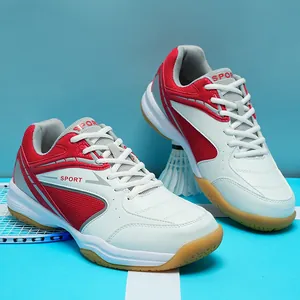 Professional red and white badminton training shoes with non-slip gum soles detail
