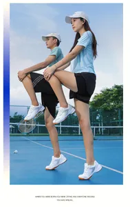 Professional lightweight breathable badminton shoes worn on a blue outdoor court surface.