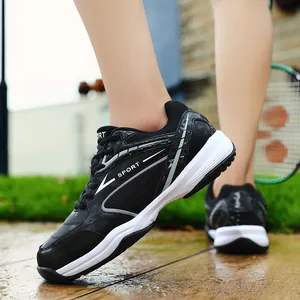 Close-up of black badminton shoes featuring breathable mesh and white 'SPORT' logo