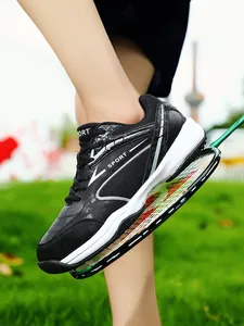 Detailed view of breathable black badminton sports shoe with white stripe design