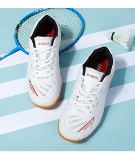 Detail view of professional white badminton shoes with breathable mesh and red accents.