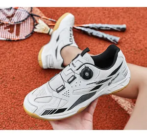 Detail view of professional white badminton shoe with rotary dial lacing system on court.