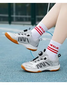 Detail of child's badminton shoes featuring a rotating dial closure and mesh upper