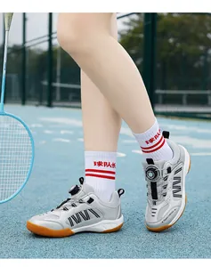 Close-up of kids badminton shoes with rotary buckle system on outdoor sports court