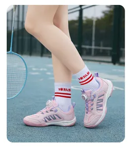 Close-up view of children's pink badminton shoes featuring a convenient rotary buckle system