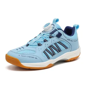 Children's light blue badminton shoes with rotary button lacing and breathable mesh.
