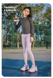Detail of purple badminton shoes for kids with rotary buckle on court