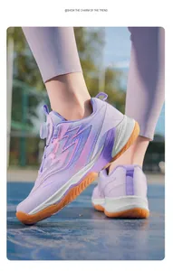 Detailed view of purple children's badminton shoes with rotary buckle lacing on court