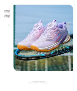Breathable kids badminton shoes with knob lacing system shown on a tennis racket.