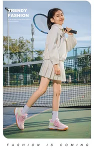Girl wearing breathable pink tennis shoes on court with racket in hand