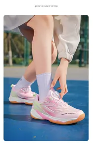 Detailed side view of pink children's badminton shoes with rotary dial lacing system.