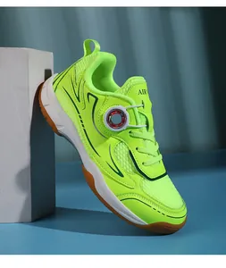 Detail view of neon green kids badminton shoe with breathable mesh and dial lacing system.