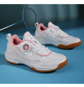 Close-up of white breathable mesh badminton shoes with pink accents and dial closure system.
