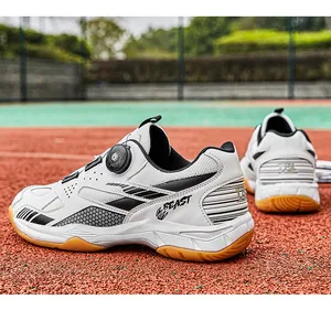 Professional white and black badminton shoes with rotary dial lacing on outdoor court background