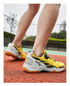 Detail of yellow breathable badminton shoes with rotary dial lacing system on court