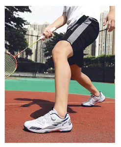 Detail view of breathable white badminton training shoes with dial lacing system.