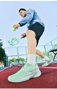Close-up of lime green breathable pickleball shoes on an outdoor court