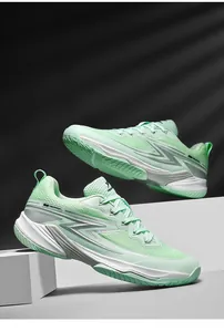 Detailed macro view of breathable mint green badminton shoes with professional non-slip sole