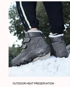 Grey children's high-top snow boots with faux fur lining and Velcro straps on snow