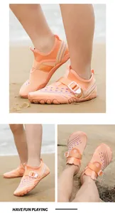 Detail showing breathable mesh and adjustable buckle of orange kids water shoes