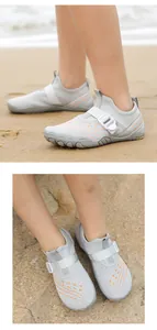 Detailed close-up of breathable mesh water shoes for kids on a sandy beach setting