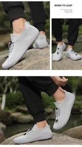 Scarpe da trekking leggere in maglia grigia con design a punta larga per esterno.
