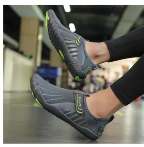 Detailed macro view of grey and green outdoor water shoes with adjustable velcro strap