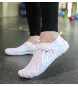 Macro view of the breathable mesh upper and adjustable strap on pink outdoor water shoes
