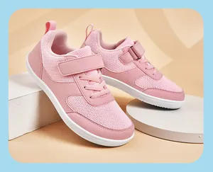 Detail view of pink children's wide-toe sports shoes with breathable mesh and velcro.