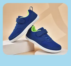 Detailed view of blue mesh children's sneakers with neon green lining on a white platform