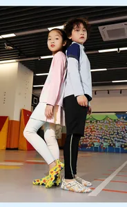 Two children wearing colorful quick-dry wading shoes in a vibrant playroom setting